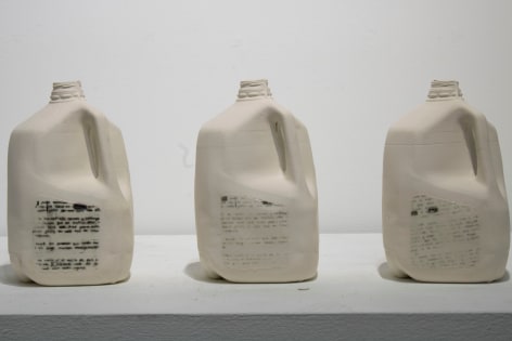 Cristina Colom-Munoz  Sueno Americano (American Dream), 2019  Slipcast Milk Jugs, screenprinted surface design  10 1/2h x 47 1/2w x 11 1/2d in 26.67h x 120.65w x 29.21d cm  CCM_001, sculptural installation of three gallon sized milk jugs with screen printed text