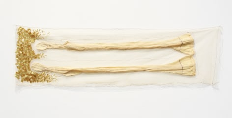 April Dauscha  Prostrate, 2019  Tulle, the artist's great- grandmother's stocking, thread glass beads  42h x 13w in -Stockings covered by tulle with beads attached