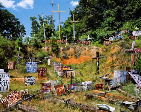 A field/gully full of rusted Christian signs and crosses. Color photograph by Burk Uzzle.