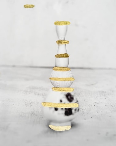 James Henkel  Repaired Bottle, 2018  Archival Pigment Print with Gold Leaf  10h x 8w in  Unique, black and white photograph of a tall vase with hand painted gold leaf details on surface.