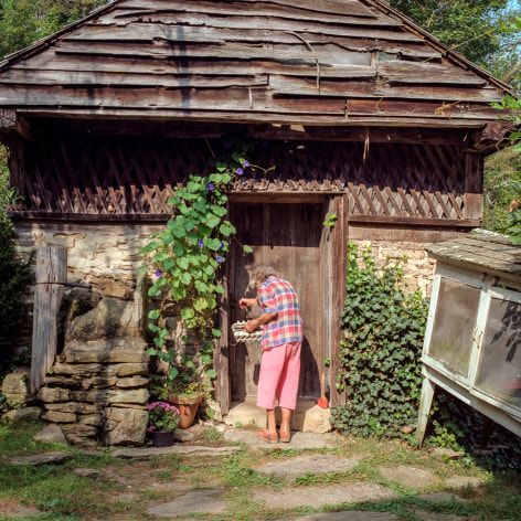Ken Abbott, Ella Early, a beloved figure in Fairview, worked in the house for Annie Ager for many years. Here she is shown entering the spring house, behind the Big House, at Hickory Nut Gap Farm, 2005 Archival Pigment Print on Cotton Rag Paper, 15h x 15w in, Edition of 15, Photography