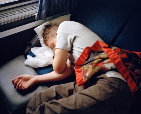 Person sleeping on train, by McNair Evans