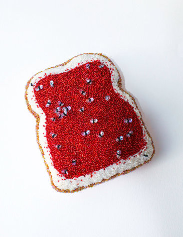 Beaded toast with jam and flies