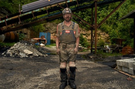Stacy Kranitz  Fed's Creek, Kentucky, 2011  Archival pigment print  16 x 24 inches, Edition of 7  27 x 40 inches, Edition of 3, Coal miner in front of piles.