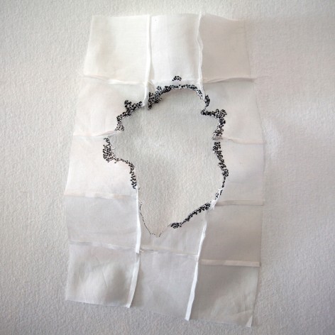 Kathryn Clark  Wunderkammer 10, 2019  Machine and hand stitched cotton organdy  19h x 11w x 3d in -Hand stitched white cotton wall sculpture with ink circulating the center