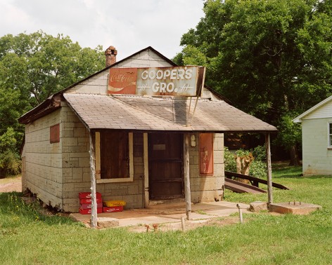 Horizontal photograph of an old southern grocery housed in a bungalow style building. The sign on the building is hand painted and reads "Coppers Gro"