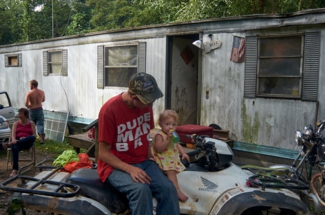 West Columbia, West Virginia, 2013  Archival Pigment Print, 16 x 24 inches, Edition of 7  27 x 40 inches, Edition of 3, Man on ATV, in front of a mobile home, West Virginia