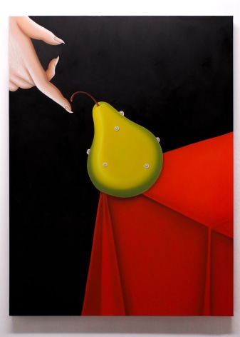 A female disconnected hand comes from the top left of the image to balance a ripe green pear that sits on the edge of a red table