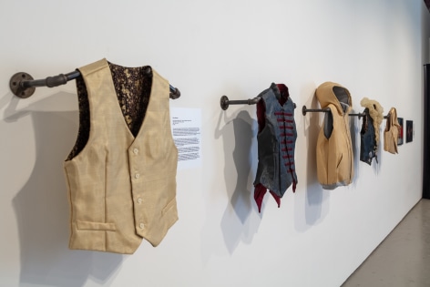 Installation view with Kevlar vests by Erika Diamond
