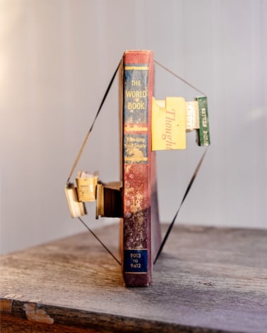 James Henkel  Addenda From The Series Books, 2020  20h x 16w in 50.80h x 40.64w cm  Edition 5  JHe_054 pieces of various books strapped to a undamaged book