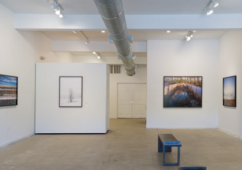 Gallery installation view of large-format, color photographs of Freshkills Park by Jade Doskow