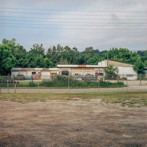 Ken Abbott  King's Transmission and 117 Auto Repair Shop, Riverside Dr., July 2003, Printed 2020  Archival Pigment Print  Image Size: 7 x 7 in Paper Size: 12 x 9 1/2 in Mat Size: 14 x 11 inches  Edition of 10  $ 300.00 unframed, photograph of a former transmission shop