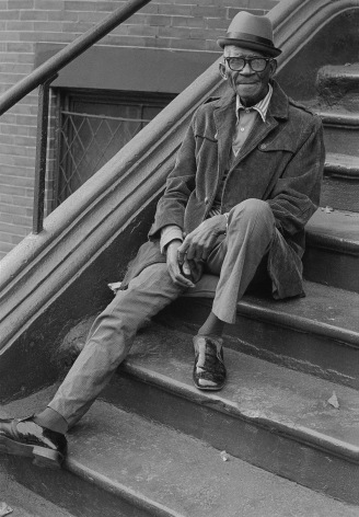 Man sitting on stoop. Photograph by Mike Smith