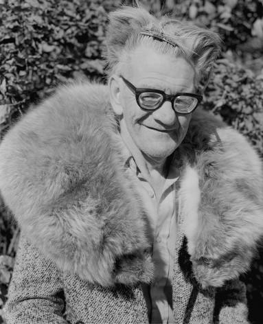 1970s black and white photograph of person in fur coat with hair clips, by Mike Smith