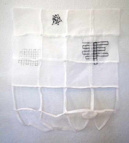 Kathryn Clark  Wunderkammer 9, 2019  Machine and hand stitched cotton organdy  18h x 13w x 3d in - white cotton wall sculpture sectioned off by squares while specific spots have ink