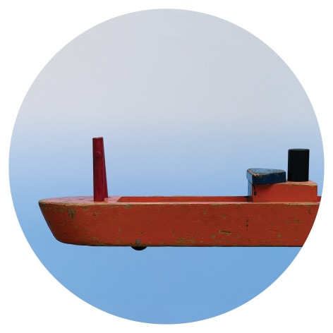 Circular image of toy boat on blue background, by Workingman Collective