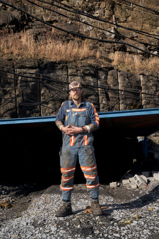 Stacy Kranitz  Welch, West Virginia, 2016  Archival Pigment Print  16 x 24 inches, Edition of 7  27 x 40 inches, Edition of 3, Vertical coal miner, with pipe behind him, West Virginia