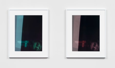 two framed photographs in white frames hanging side by side. the left image is a portrait of Barron Trump tinted green and the right hand image is the same, but tinted rose