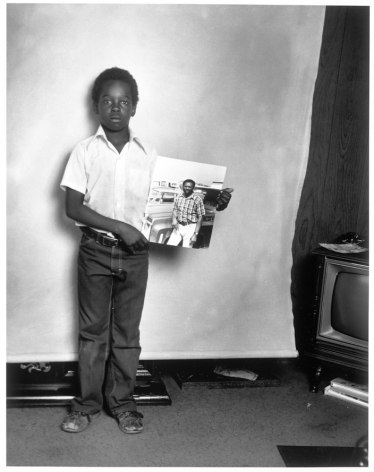 Leon Borensztein, Black Boy with Picture of His Father, Fremont, California, 1979