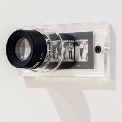 Oscar Mu&ntilde;oz, 3-3A, 2008. Magnifying glass and four contact negatives installed on wall, 1 5/8 x 4 3/8 in.