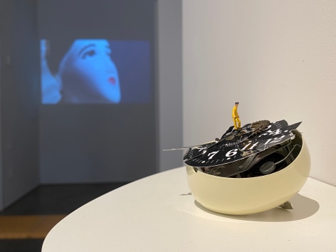 Liliana Porter, To Fix It [Man in Yellow], 2020. Broken table clock and figurine, 3 x 4 1/2 x 3 in. (7.6 x 11.4 x 7.6 cm.)