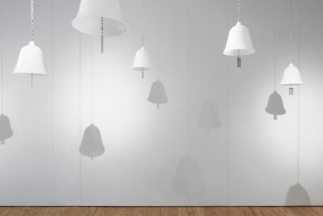 Marie Orensanz, ...in honor... of whom?, 1999-2015, 20 white opaline bells (9.5 x 10.2 in each) with stainless steel tags (3.1 x 1.8 in each), Installation view, 2015.
