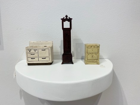 Liliana Porter, For Sale [Furniture and Toll Clock], 2018. Objects on white shelf, 6 1/2 x 10 1/2 x 6 1/2 in. (16.5 x 26.7 x 16.5 cm.)