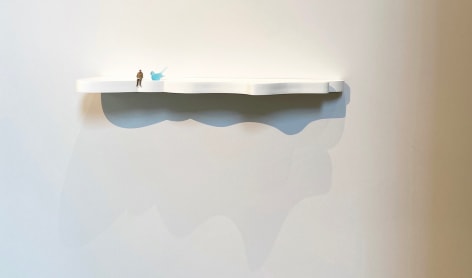 Liliana Porter, To Read, 2019. Glass bird and resin figurine on shelf, 43 x 10 1/2 x 4 in. (109.2 x 26.7 x 10.2 cm.)