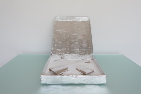 Ramiro Chaves, XNY, 2013. Pizza box, aluminum adhesive tape incised by typewriter, salt and cardboard, 4 in. x 33 3/4 in. x 16 1/2 in.