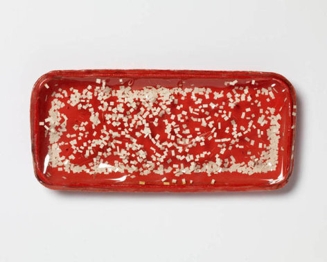 S&eacute;rvulo Esmeraldo, Foodtainer 1, 1966. Red box, plastic film, paper, 4-3/4&rdquo; x 8-3/4&rdquo; x 7/8&rdquo; /  12 x 22.2 x 2.2 cm