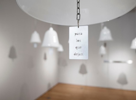 Marie Orensanz, ...in honor... of whom?, 1999-2015, 20 white opaline bells (9.5 x 10.2 in each) with stainless steel tags (3.1 x 1.8 in each), Installation view, 2015.