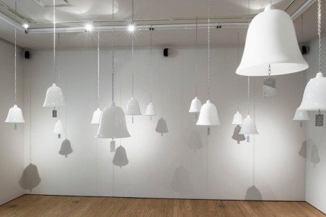 Marie Orensanz, ...in honor... of whom?, 1999-2015. 20 white opaline bells (9.5 x 10.2 in each) with stainless steel tags (3.1 x 1.8 in each). Installation, dimensions variable.