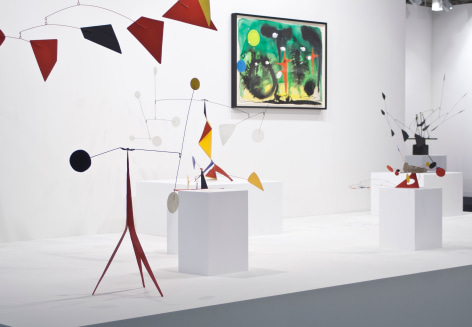 Installation view of Art Basel | Basel 2014, booth A8 featuring one green, black and red watercolor by Alexander Calder and five standing mobile as well as a segment of a suspended mobile.  &copy; 2018 Calder Foundation, New York / Artist Right Society (ARS), New York. &copy;Helly Nahmad Gallery NY