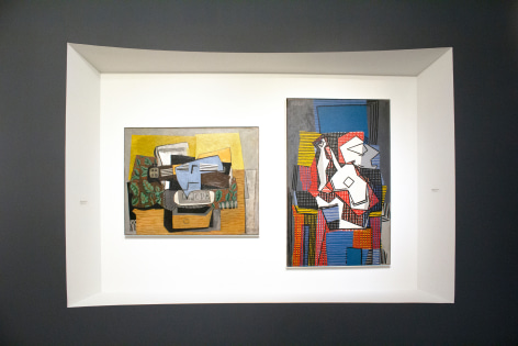 Installation view of The Climax of Cubism, booth 301 at TEFAF Spring 2019. Photography by Studio MDA. This photo features two paintings by Pablo Picasso, on the left, Violon et Journal sur Tapis Vert (le jour)  (Violin and Newspaper on a Green Carpet (daytime))