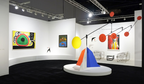 Installation view of Art Basel | Miami Beach 2017, booth A4. This photo features two paintings and two sculptures.  The painting on the left is by Joan Miro, it's called, Joan Mir&oacute;, Oiseaux en F&ecirc;te pour le lever du Jour, 21 Mars 1968, it was made in 1968, the materials are, oil on canvas 130 x 195 centimeters. (51 1/8 x 76 3/8 inches.) The second painting is by Max Ernst, it's called A Maiden, a Widow and a Wife, it was made in 1966, the materials are oil on canvas, the size is  92 x 76 centimeters. (36 1/4 x 30 inches.) The large scale sculpture in the middle of the photo is by Alexander Calder, it's called Untitled and was made in 1955, the materials are sheet metal, rod, wire and paint, the size is 108 5/8 x 1421&frasl;2 x 59 inches or 276 x 362 x 150 centimeters. The small scale sculpture is a standing mobile by Alexander Calder and is called Maquette for Th&eacute;&acirc;tre de Nice, it was made in 1970, the materials are painted sheet metal, brass and wire, the size is, 51 x 56 x 42 centimeters or (20 1/8 x 22 in. x 16 1/2 inches.) Photography by Studio MDA.  &copy; 2018 Calder Foundation, New York / Artist Right Society (ARS), New York. &copy;Helly Nahmad Gallery NY.