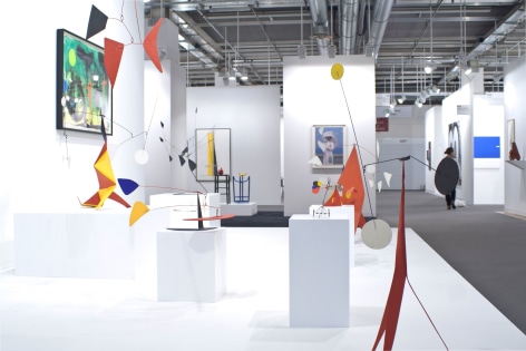 Installation view of Art Basel | Basel 2014, booth A8 featuring from profiel a few standing mobile by Alexander Calder and the green and black watercolor.  &copy; 2018 Calder Foundation, New York / Artist Right Society (ARS), New York. &copy;Helly Nahmad Gallery NY