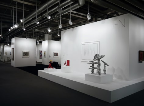 Installation view of Art Basel | Basel 2015, booth H5 featuring Jean Dubuffet's sculpture, Groupe de Quatre Arbres (&Eacute;tat D&eacute;finitif), made in 1970, on the wall there is a white painting by Lucio Fontana that has seven slashes, it is called, Concetto Spaziale, Attese, made in 1965, the material list is water paint on canvas and lacquered wood frame, the size is 100 x 133.3 centimeters. (39 3/8 x 52 inches.).  &copy; 2018 Calder Foundation, New York / Artist Right Society (ARS), New York. &copy;Helly Nahmad Gallery NY