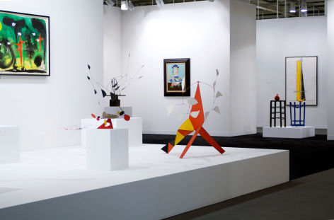 Installation view of Art Basel | Basel 2014, booth A8, featuring four sculptures and two paintings and one watercolor. The watercolor is by Alexander Calder and is called, Untitled, made in 1953, watercolor on paper 73.66 x 107.95 centimeters or (29 x 42.5 inches.). The painting in the middle of the photo is by Pablo Picasso and is called, La fille de l&rsquo;artiste &agrave; deux ans et demi avec un bateau, (The daughter of the artist at two years old holding a boat) it was made in 1938, Oil on canvas 73 x 54 centimeters. (28 3/4 x 21 1/4 inches.) There is three standing mobile by Alexander Calder in the middle of the photo, two of them rest on pedestals while one stands directly on the ground on its three legs. The first standing mobile is called, The Amoeba, it was made in 1974, it is made of painted sheet metal, wire and brass, the size is 27.3 x 60.9 x 60.9 centimeters or (103&frasl;4 x 24 in. x 24 inches.) The second mobile by Alexander Calder is called Five White against Five White and was made in 1973 it s made of painted metal and wire standing mobile 104.1 x 121.9 x 73.7 cm. (41 x 48 in. x 29 in.),on the right of the photo there is a sculpture by Joan Miro, called&quot; Homme et Femme dans la Nuit&quot;, 1969 Sculpture: Painted bronze 86.5 x 72 x 50 cm. (34 x 28 1/3 in. x 19 in.)&copy; 2018 Calder Foundation, New York / Artist Right Society (ARS), New York. &copy;Helly Nahmad Gallery NY