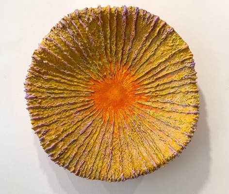 Image of Barry Katz's three dimensional artwork entitled the Number 4 showing a slightly cupped circular form with lines on it painted in ochre, pink and orange.