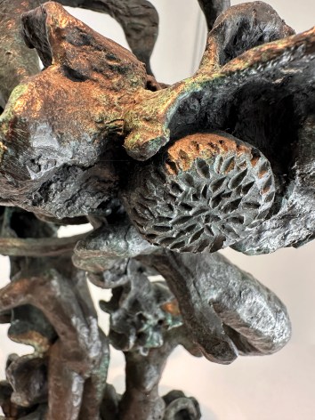 Close-up image of organic abstract bronze sculpture titled Woman Dancing About Trees by Yulla Lipchitz.