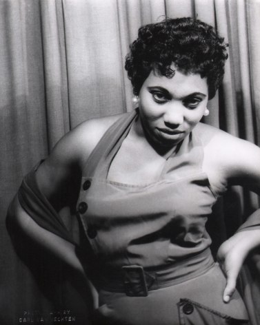 Carl Van Vechten, Leontyne Price in Porgy &amp; Bess, ​1953. Subject poses against a curtain with hands on hips, looking to the camera.