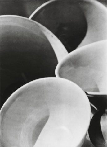 Paul Strand, Bowls, ​1916. Four white bowls overlapping with dramatic shadows.