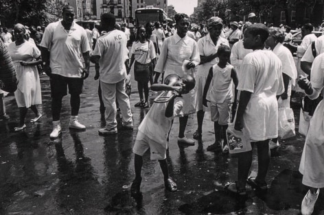 Boy Bends Notes on a Broken Trombone: More than a hundred followers of Daddy Grace gather in Central Harlem for an annual August street baptism, organized by the United House of Prayer, 1994.