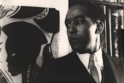 Carl Van Vechten, Langston Hughes, ​1932. Subject poses looking to the left beside a painting with the figure in the same pose.