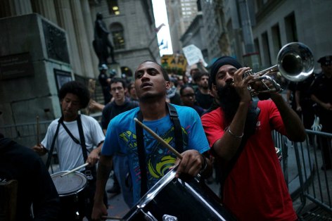 02. Drums and Trumpet on Wall Street: Members of the Occupy Wall Street Movement marched from Zucotti Park to the New York Stock Exchange at the end of the trading day, Sept. 2011.