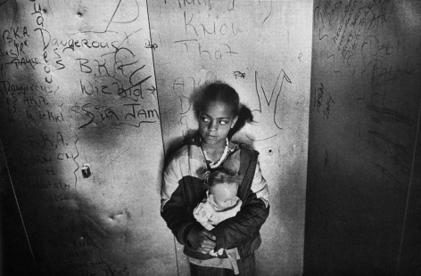 Eli Reed,&nbsp;A child clutching her doll in an elevator, San Francisco, CA, 1981