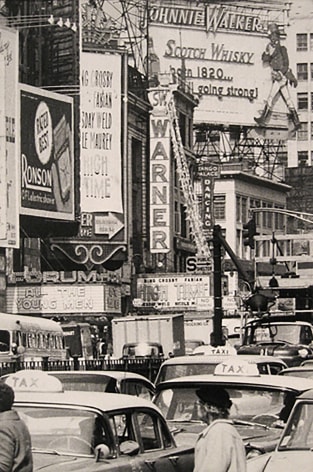 5. Caio Garrubba, Untitled, ​1960. Times Square street scene with various advertisements and marquees. Taxis and pedestrians in the street in the foreground.