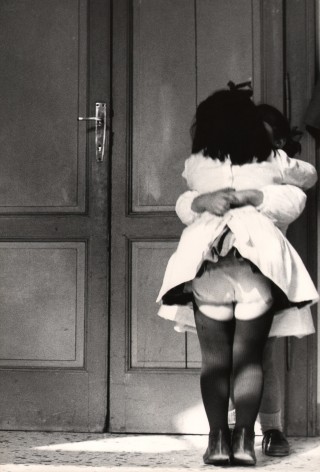 10. Renzo Tortelli, Piccolo Mondo, 1958&ndash;1959. High contrast image. Two little girls in white dresses embrace in front of a doorway.
