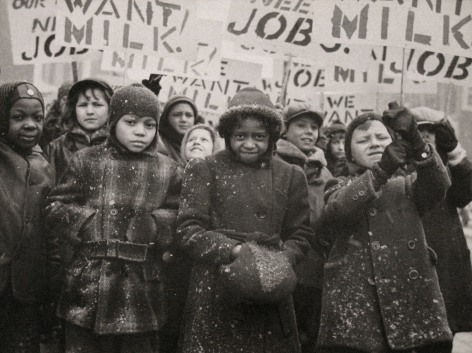 Gordon Coster, Untitled, ​c. 1938. Crowd of children in winter coats holding signs above their heads. Signs are in partial view, but the words &quot;MILK&quot; AND &quot;JOB&quot; can be seen.
