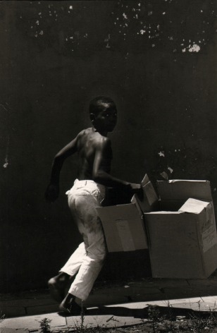 8.&nbsp;Anthony Barboza (African-American, b. 1944), Rushing Home with Moving Boxes, Pensacola, Florida, 1966